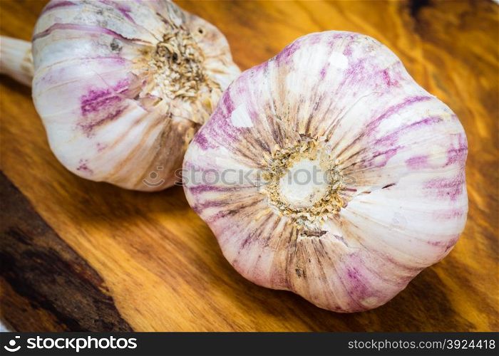 Healthy food. Organic whole garlic on rustic wooden table background