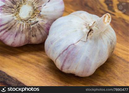Healthy food. Organic whole garlic on rustic wooden table background