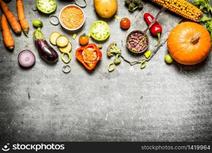 Healthy food. Pieces of fresh vegetables and beans. On the stone table.. Healthy food. Pieces of fresh vegetables and beans.