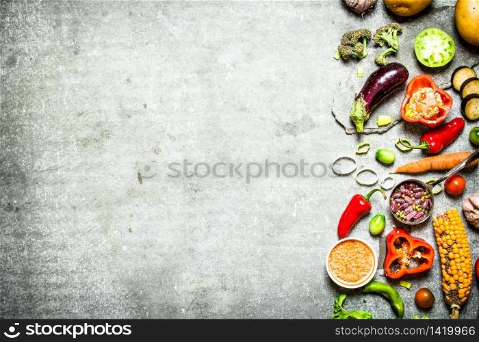 Healthy food. Pieces of fresh vegetables and beans. On the stone table.. Healthy food. Pieces of fresh vegetables and beans.