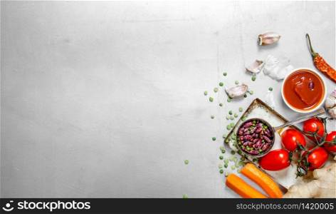 Healthy food . Raw vegetables with beans and spices. On the steel background. Raw vegetables with beans and spices.