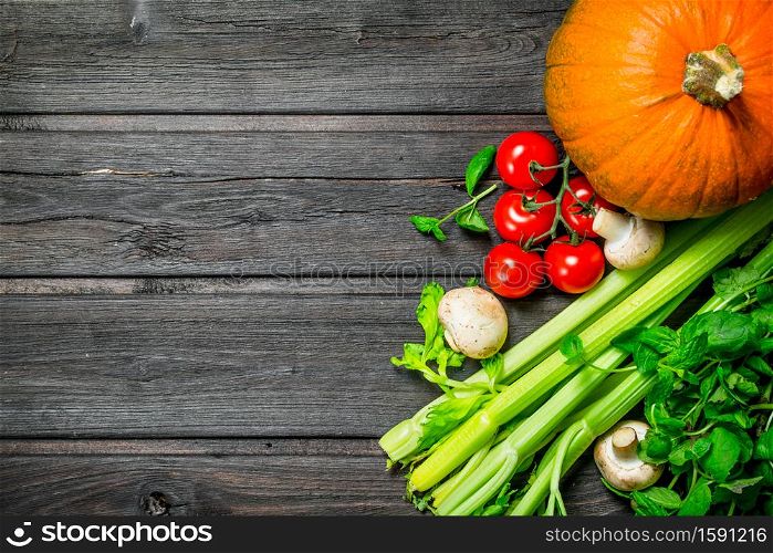 Healthy food. Ripe organic vegetables and mushrooms. On a wooden background.. Healthy food. Ripe organic vegetables and mushrooms.