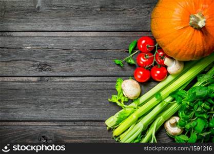 Healthy food. Ripe organic vegetables and mushrooms. On a wooden background.. Healthy food. Ripe organic vegetables and mushrooms.