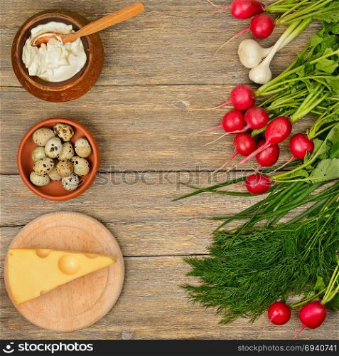 Healthy food (vegetables, cheese, egg, sour cream) on old wooden table. Top view.