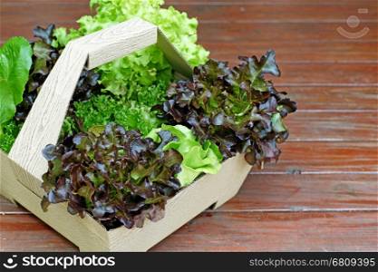 healthy food, vegetables salad in basket on wooden floor