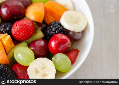 Healthy fresh fruit salad in white plate. Top view.. Healthy fresh fruit salad in white plate. Top view.
