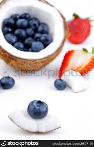 healthy fresh fruits - strawberry, blueberry and coconut isolated on white background