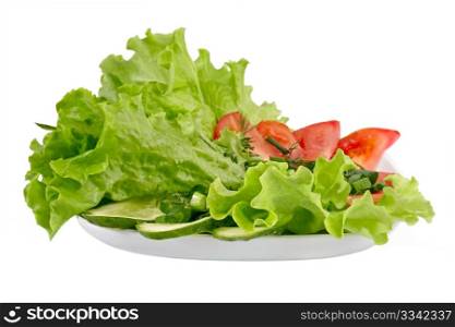 Healthy garden salad with tomatoes and cucumbers and salad leaves. Objects over white.