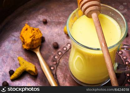 Healthy golden milk. Turmeric Golden milk in a glass cup