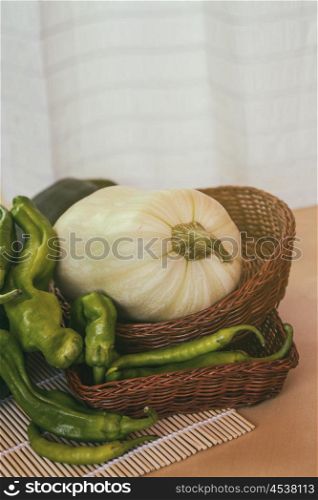Healthy green peppers and a pumpkin