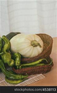 Healthy green peppers and a pumpkin