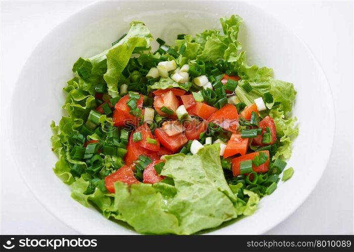 Healthy green salad, in white bowl.