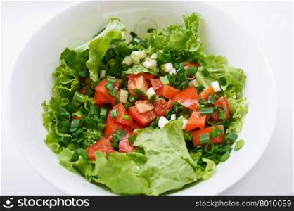Healthy green salad, in white bowl.