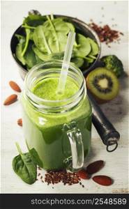 Healthy green smoothie and ingredients on white - superfoods, detox, diet, health, vegetarian food concept