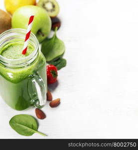 Healthy green smoothie and ingredients on white - superfoods, detox, diet, health, vegetarian food concept. Background layout with free text space.