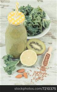 Healthy green smoothie from fruits and vegetables as source natural vitamins. Concept of slimming and nutritious dessert. Healthy smoothie from fruits and vegetables as source vitamins. Slimming and nutritious dessert concept