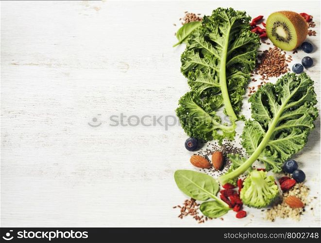 Healthy green smoothie or salad ingredients on white - superfoods, detox, diet, health or vegetarian food concept. Background layout with free text space.
