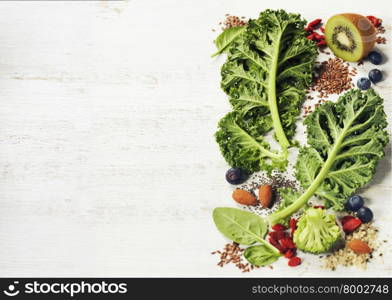Healthy green smoothie or salad ingredients on white - superfoods, detox, diet, health or vegetarian food concept. Background layout with free text space.