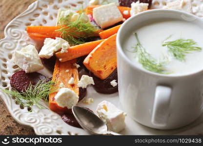 Healthy grilled beet, carrots salad with cheese feta, fennel and Greek yogurt in small glass bowls on the rustic wooden table, top view.. Healthy grilled beet, carrots salad with cheese feta, fennel and Greek yogurt in small glass bowls on the rustic wooden table, top view