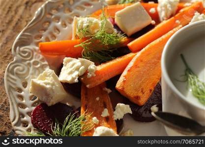 Healthy grilled beet, carrots salad with cheese feta, fennel and Greek yogurt in small glass bowls on the rustic wooden table, top view.. Healthy grilled beet, carrots salad with cheese feta, fennel and Greek yogurt in small glass bowls on the rustic wooden table, top view