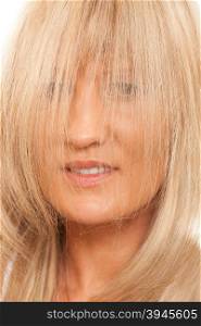 Healthy hair hairstyling hairdressing concept. Woman covering her face with long straight hair.