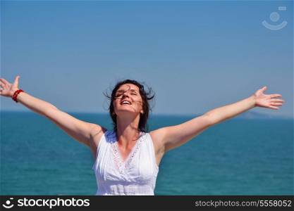 healthy Happy young woman with spreading arms, blue sky with clouds in background - copyspace