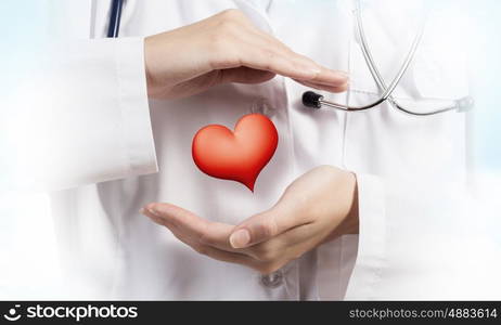 Healthy heart. Close up of female doctor holding heart in hands