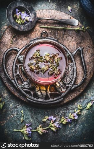 Healthy herbal tea concept , cup of tea with fresh herbs and flowers on rustic vintage background, top view