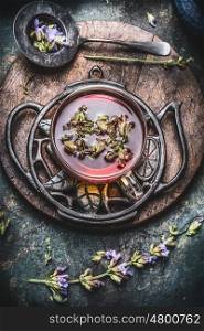 Healthy herbal tea concept , cup of tea with fresh herbs and flowers on rustic vintage background, top view
