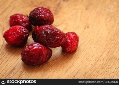 Healthy high fiber food organic nutrition. Close up dried cranberries cranberry fruit on wooden table