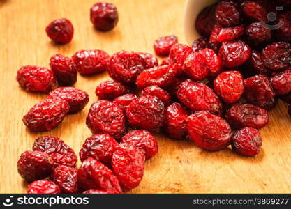 Healthy high fiber food organic nutrition. Close up dried cranberries cranberry fruit on wooden table