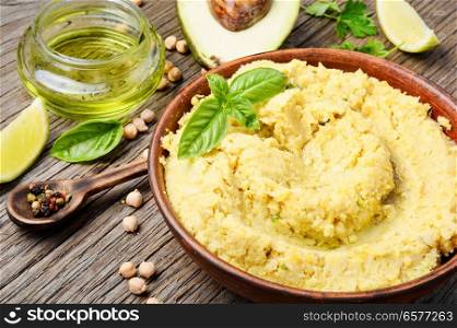 Healthy homemade creamy hummus of chickpeas. Hummus on rustic wooden table