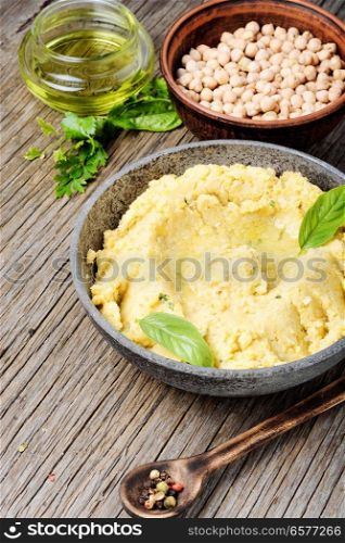 Healthy homemade creamy hummus of chickpeas. Hummus on rustic wooden table