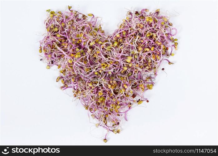 Healthy kale sprouts in shape of heart containing natural vitamins and minerals. White background. Healthy kale sprouts in shape of heart containing vitamins and minerals. White background