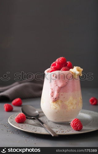 healthy layered raspberry banana smoothie in glass