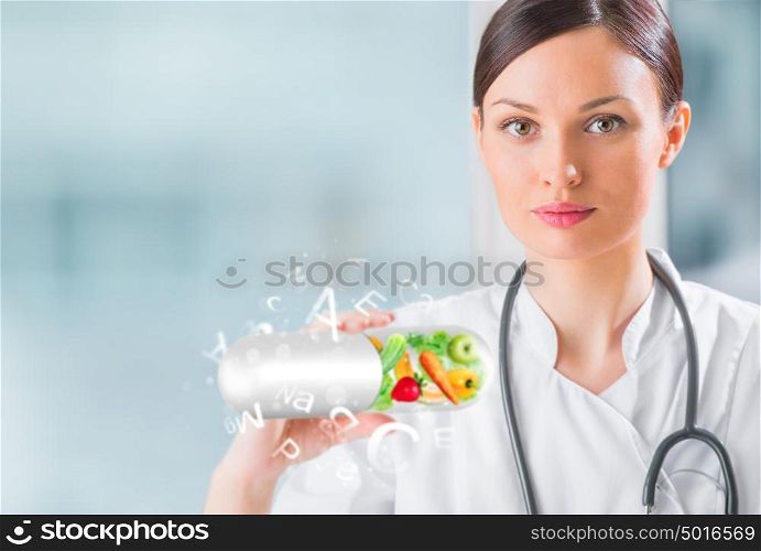 Healthy life concept. Female medical doctor holding vitamins
