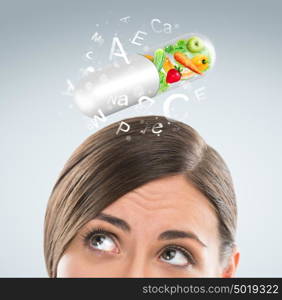 Healthy life concept. Woman with vitamins overhead