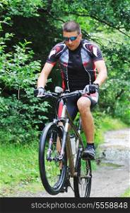 healthy lifestyle and fitness concept with mount bike man who ride bike outdoor