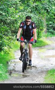 healthy lifestyle and fitness concept with mount bike man who ride bike outdoor