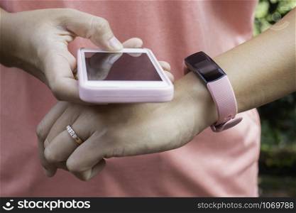 Healthy lifestyle concept female wearing sport tracker wristband arm, stock photo