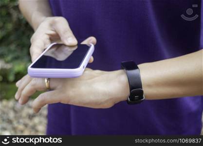 Healthy lifestyle concept female wearing sport tracker wristband arm, stock photo