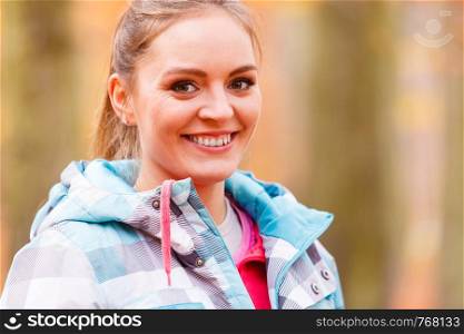 Healthy lifestyle concept. Portrait of attractive sporty smiling girl wearing sports clothes. Woman prepare herself to exercising in autumnal forest.. Portrait of active sporty girl.