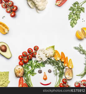 Healthy lifestyle concept. Various fresh vegetables with funny face made with ingredients on white background, top view, frame. Layout for Detox, dieting and clean eating food