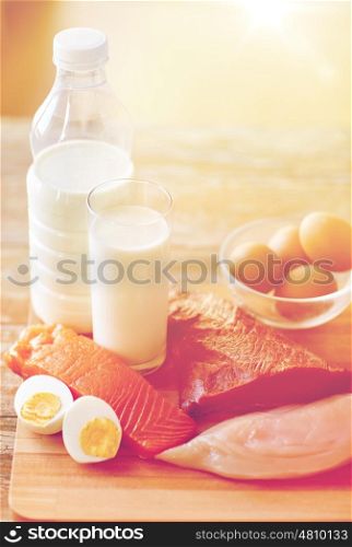 healthy lifestyle, culinary, cooking and diet concept - close up of natural protein food still life on wooden table in kitchen