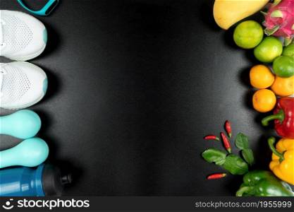Healthy lifestyle, food and sport concept. athlete&rsquo;s equipment and fresh fruit on black background.