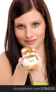 Healthy lifestyle - happy woman eat caprese sandwich