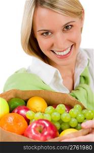 Healthy lifestyle - woman with fruit shopping paper bag on white background