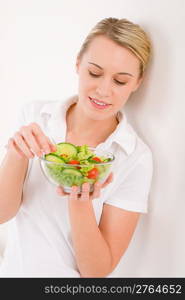 Healthy lifestyle - woman with vegetable salad on white