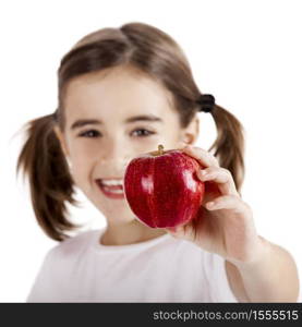Healthy little girl holding and showing a red apple