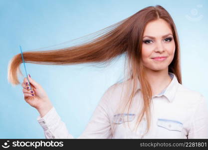 Healthy look concept. Girl combing brushing her hair by using plastic comb. Young woman taking care of everyday hygiene and natural beauty.. Long haired woman combing her hair.
